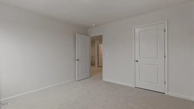 a view of an empty room and closet area