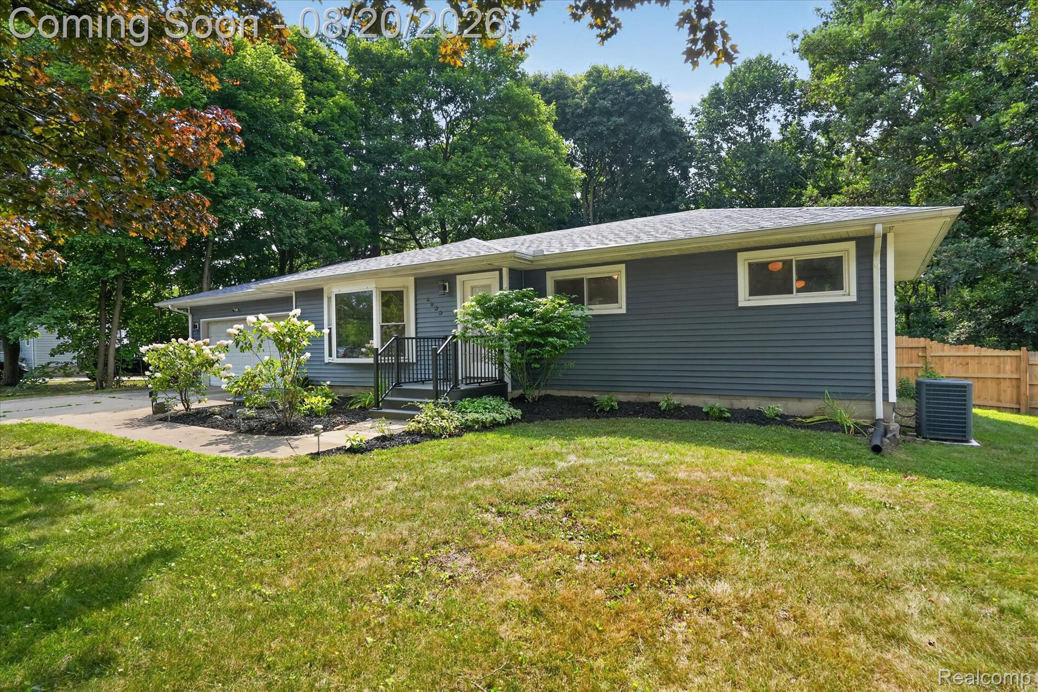6235 Waldon Road Clarkston, MI 48346 - Photo 3 of 41 Ranch-style exterior with gray horizontal siding, white trim, and a shingled roof