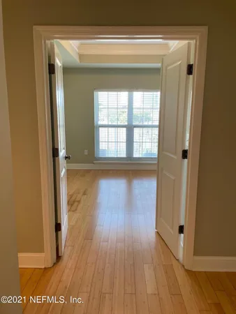an empty room with wooden floor and closet