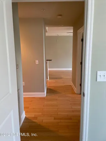 a living room with furniture potted plant and a large window