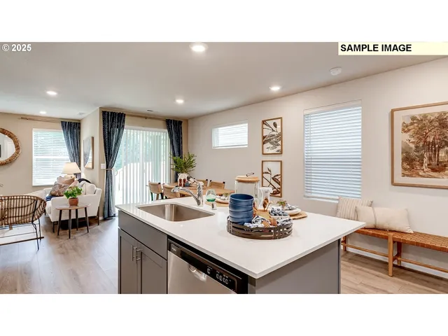 a kitchen with a sink appliances and a dining table
