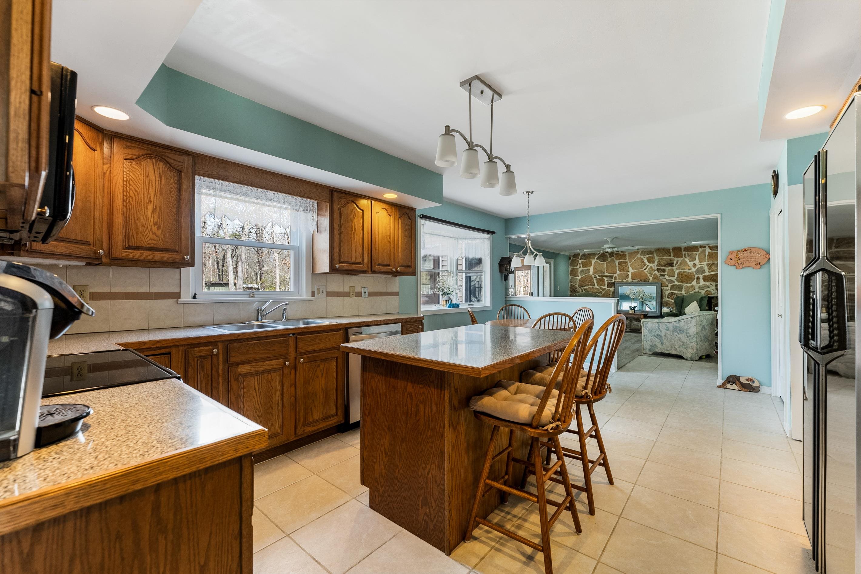 95 Peach Orchard Road Ocean View, NJ 08230 - Photo 13 of 41 a kitchen with stainless steel appliances granite countertop sink microwave and wooden cabinets