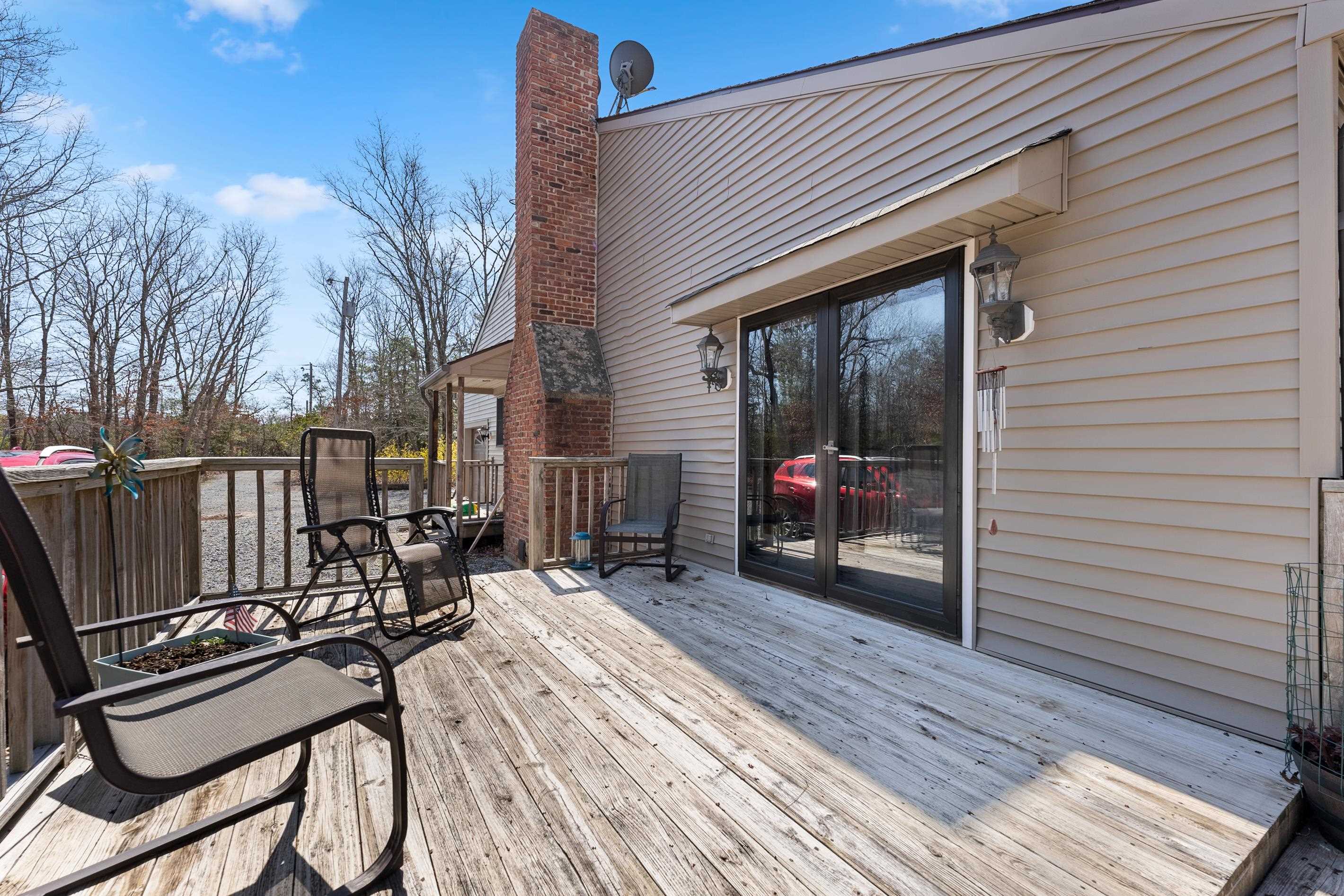 95 Peach Orchard Road Ocean View, NJ 08230 - Photo 35 of 41 a view of a patio with a table and chairs and wooden floor
