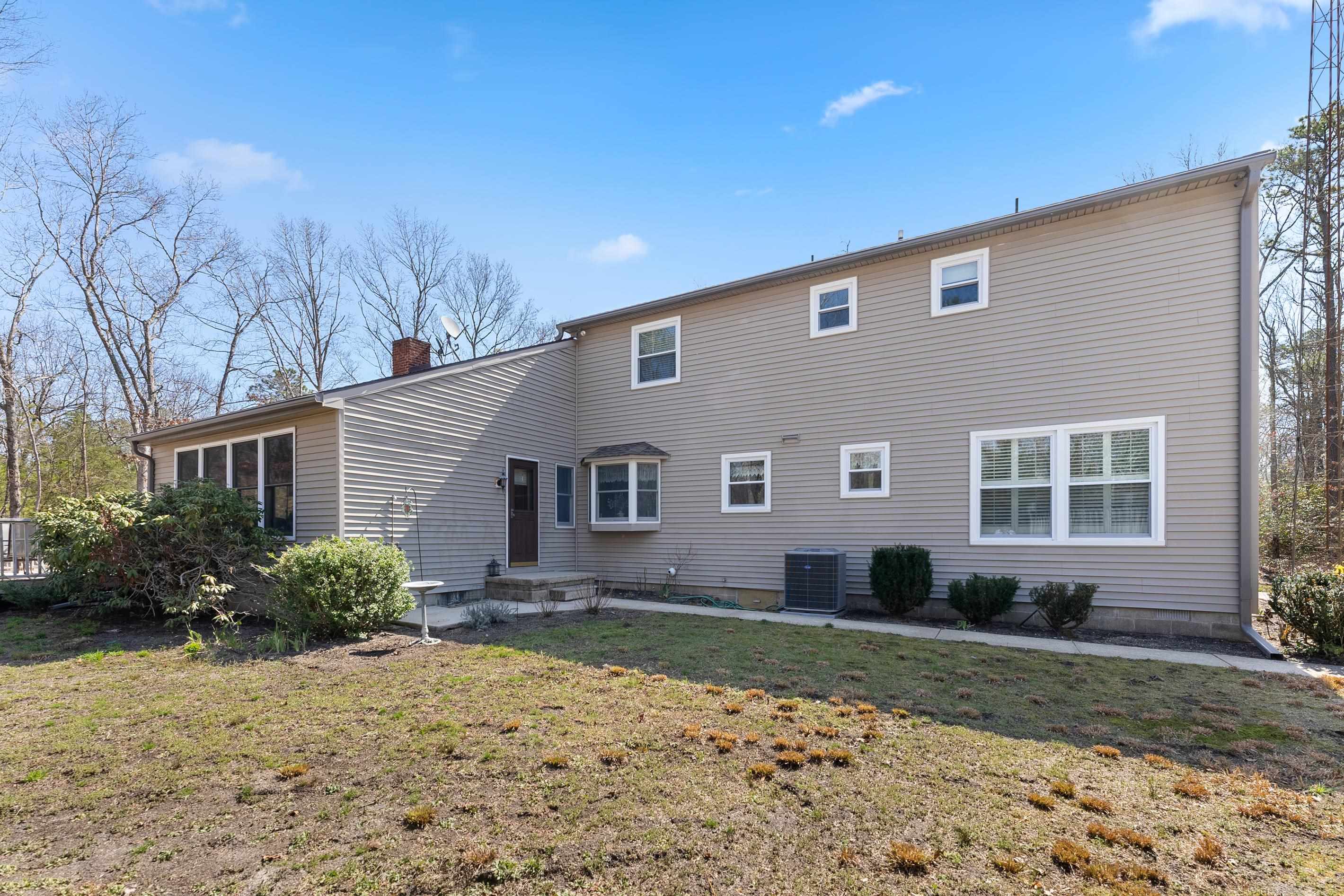 95 Peach Orchard Road Ocean View, NJ 08230 - Photo 39 of 41 a front view of a house with a yard and garage