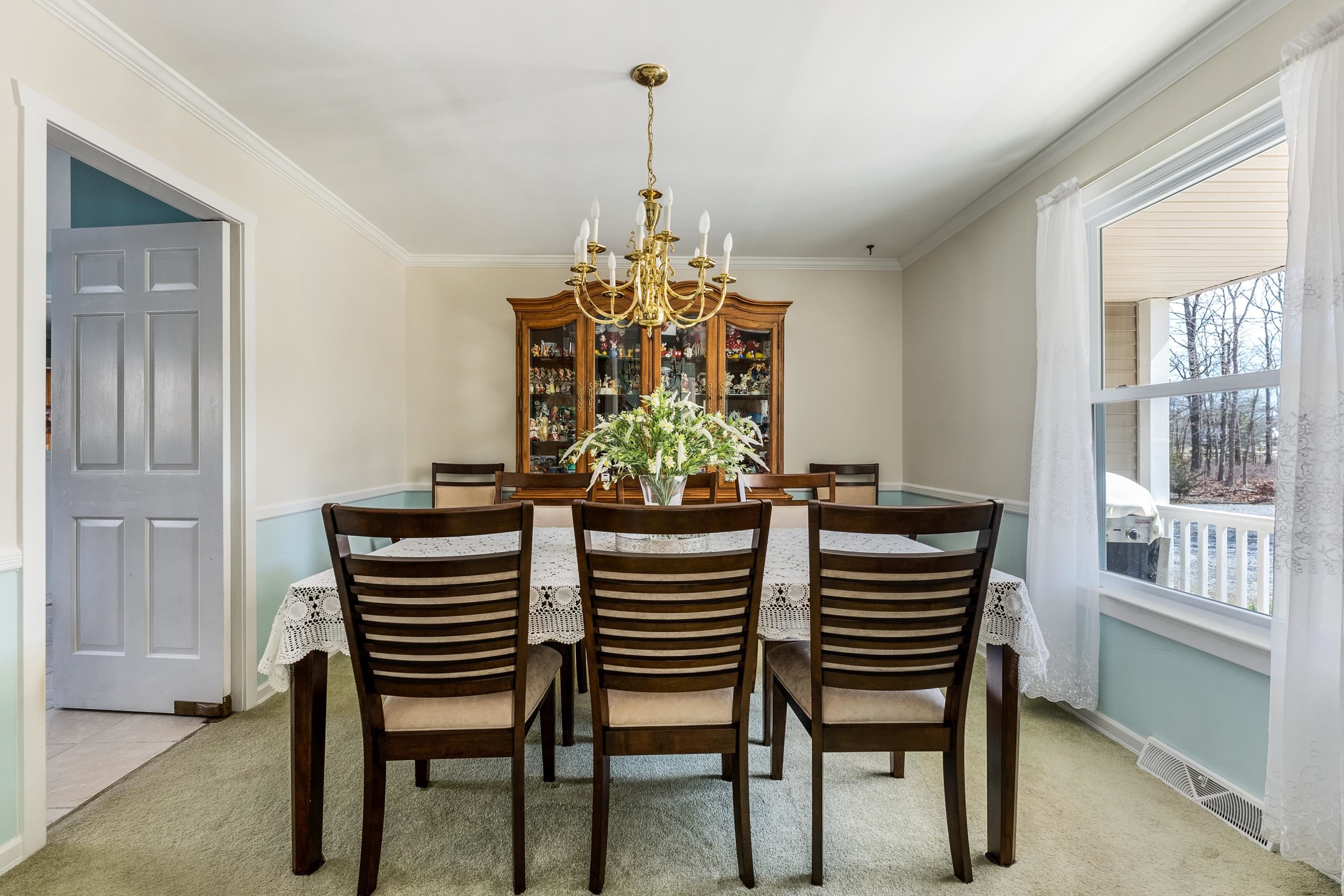95 Peach Orchard Road Ocean View, NJ 08230 - Photo 8 of 41 a dining room with furniture a chandelier and window