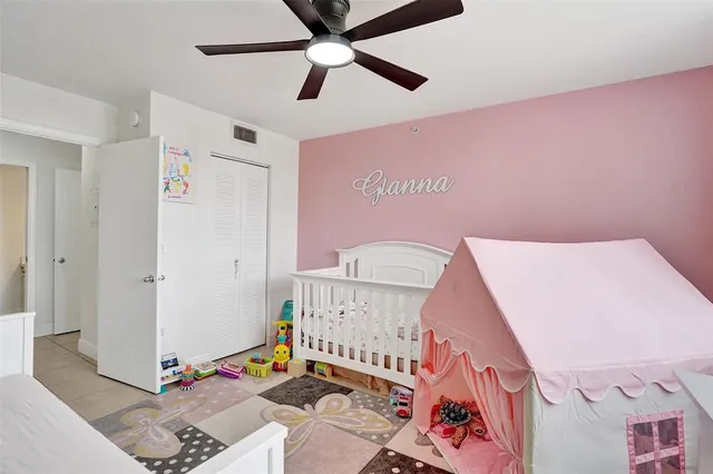 a living room with a baby crib furniture and a chandelier