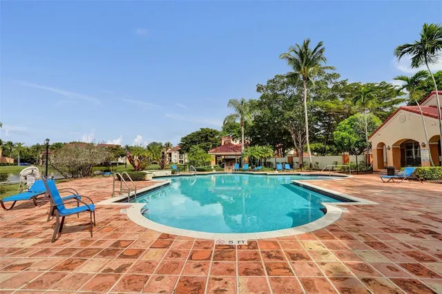 a view of a swimming pool with a lake view and houses in the back