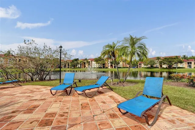 a view of a patio with a dining table and chairs with a wooden fence