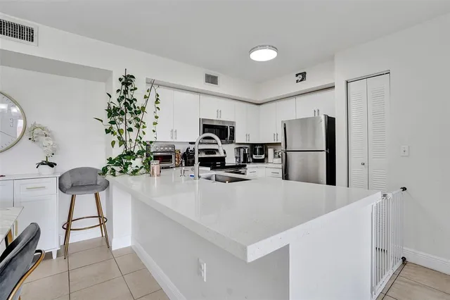 a kitchen with stainless steel appliances a refrigerator and a stove