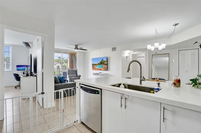 a kitchen with stainless steel appliances a sink stove and cabinets