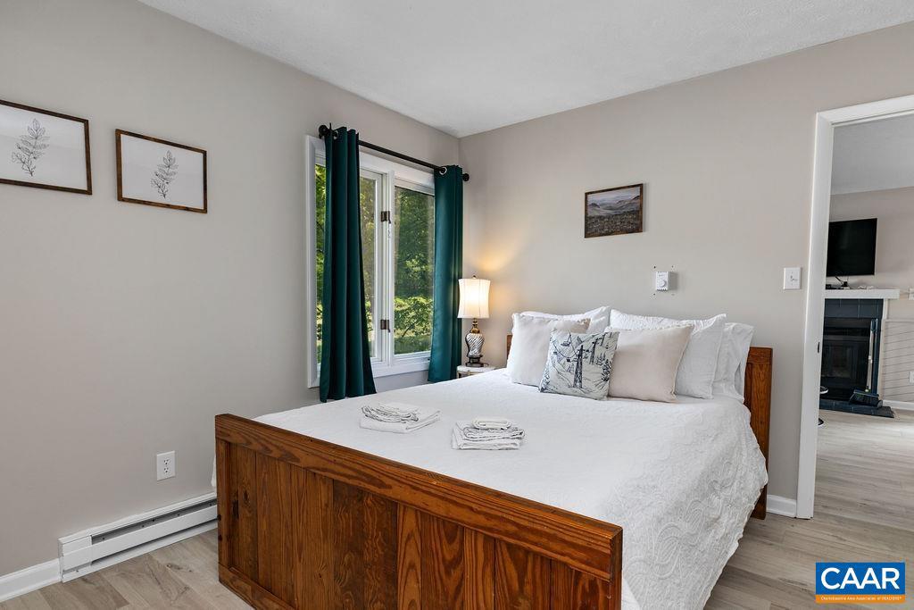 2209 Tanners Ridge Roseland, VA 22967 - Photo 11 of 21 a large bedroom with a bed and a flat tv screen on dresser