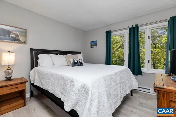 a bedroom with bed and window