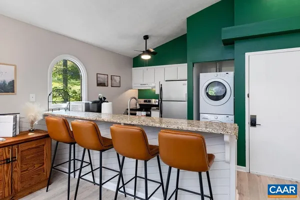 a kitchen with a table chairs refrigerator and sink