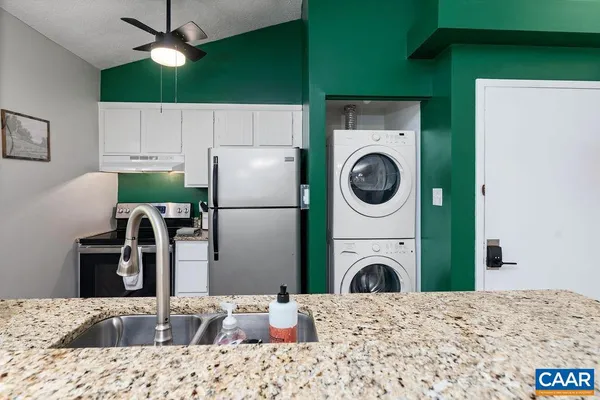 a kitchen with a refrigerator sink and washer