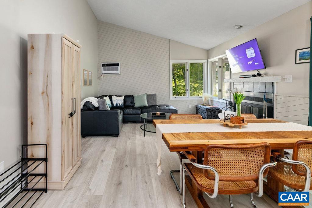 2209 Tanners Ridge Roseland, VA 22967 - Photo 6 of 21 a living room with furniture a fireplace and a floor to ceiling window
