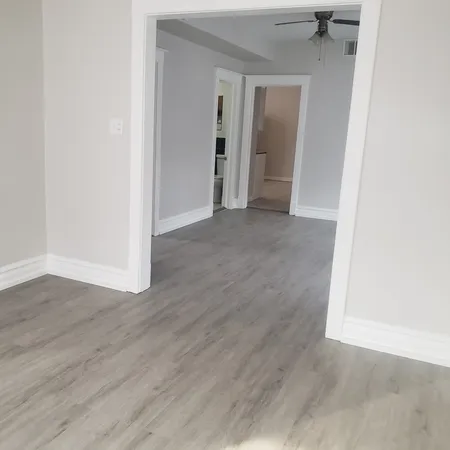an empty room with wooden floor and closet