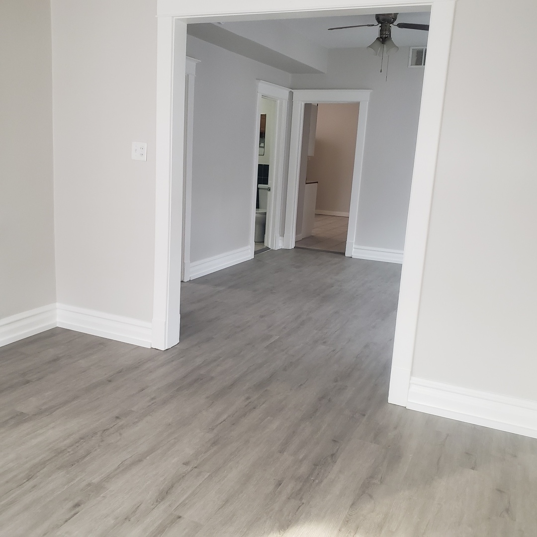 36 West 103rd Place, Unit 2 Chicago, IL 60628 - Photo 4 of 10 an empty room with wooden floor and closet