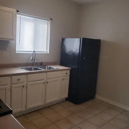 a kitchen with a sink and a mirror