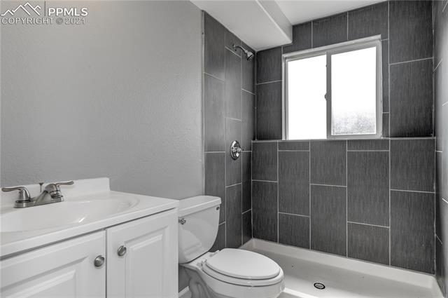 1744 Whitehall Road Colorado Springs, CO 80906 - Photo 18 of 25 Downstairs bathroom. Fully remodeled with new tile, vanity, toilet and paint.
