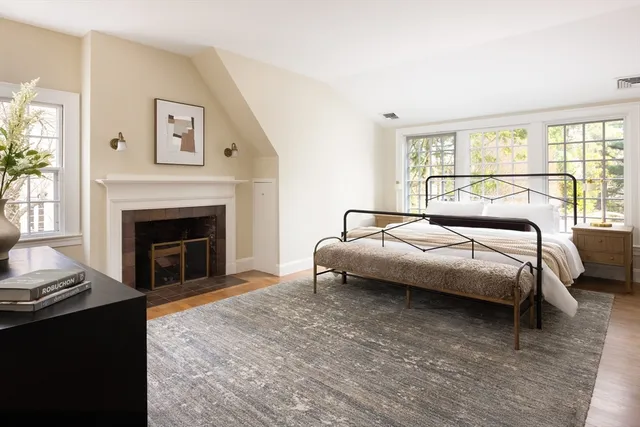 a bedroom with a bed and a fireplace