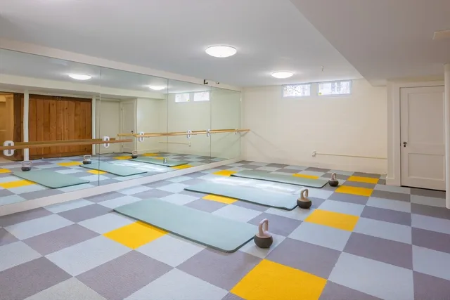 a room with pool table and windows