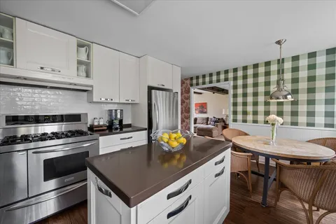 a kitchen with a sink stove and cabinets
