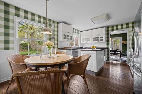 a dining room with furniture a rug and wooden floor