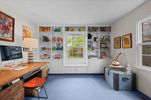 a room with furniture and a bookshelf