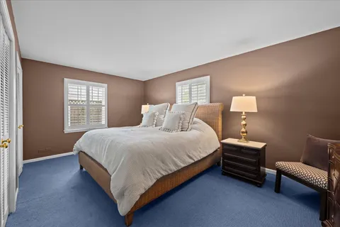 a bedroom with bed and a couch