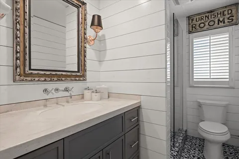 a bathroom with a sink toilet and shower