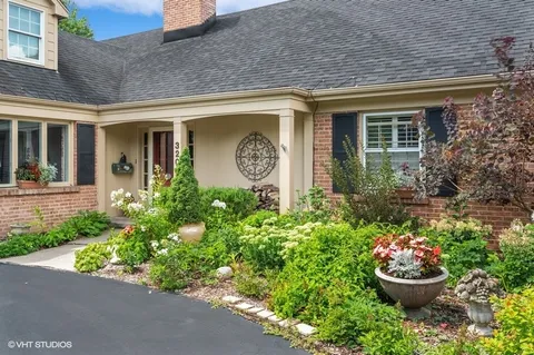 a front view of a house with a yard and fountain