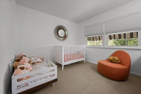 a bedroom with furniture and a window