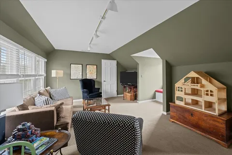 a living room with furniture a flat screen tv and large window