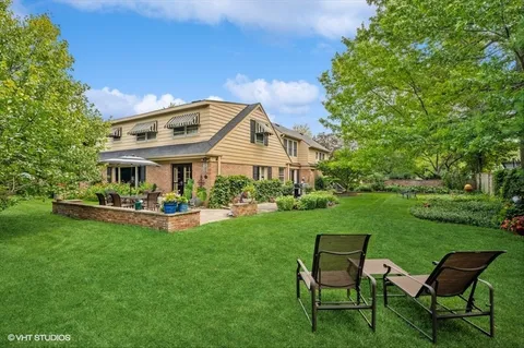a front view of a house with a garden and patio