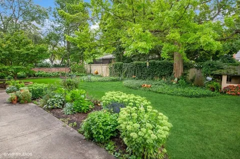 a view of a garden with a house in the background
