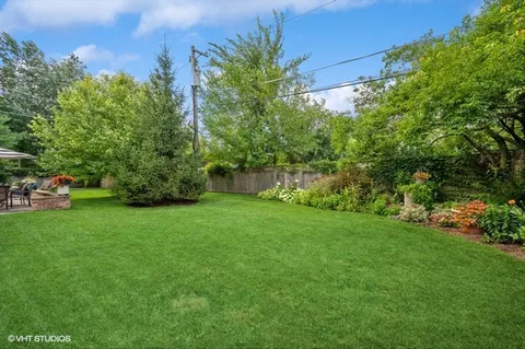a backyard of a house with lots of green space and garden