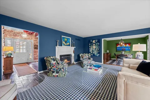 a living room with furniture a rug and a fireplace