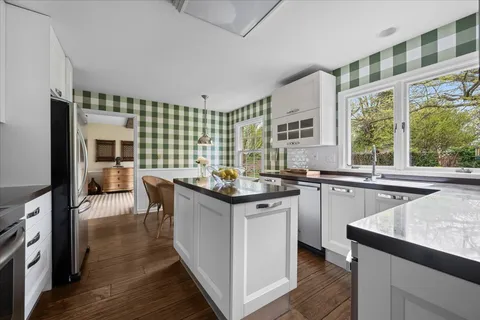 a kitchen with granite countertop a stove and a sink