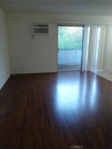 a view of room with window and wooden floor