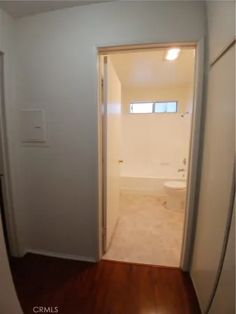 an empty room with wooden floor and a window