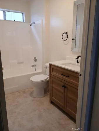 a bathroom with a granite countertop toilet a sink and a bathtub