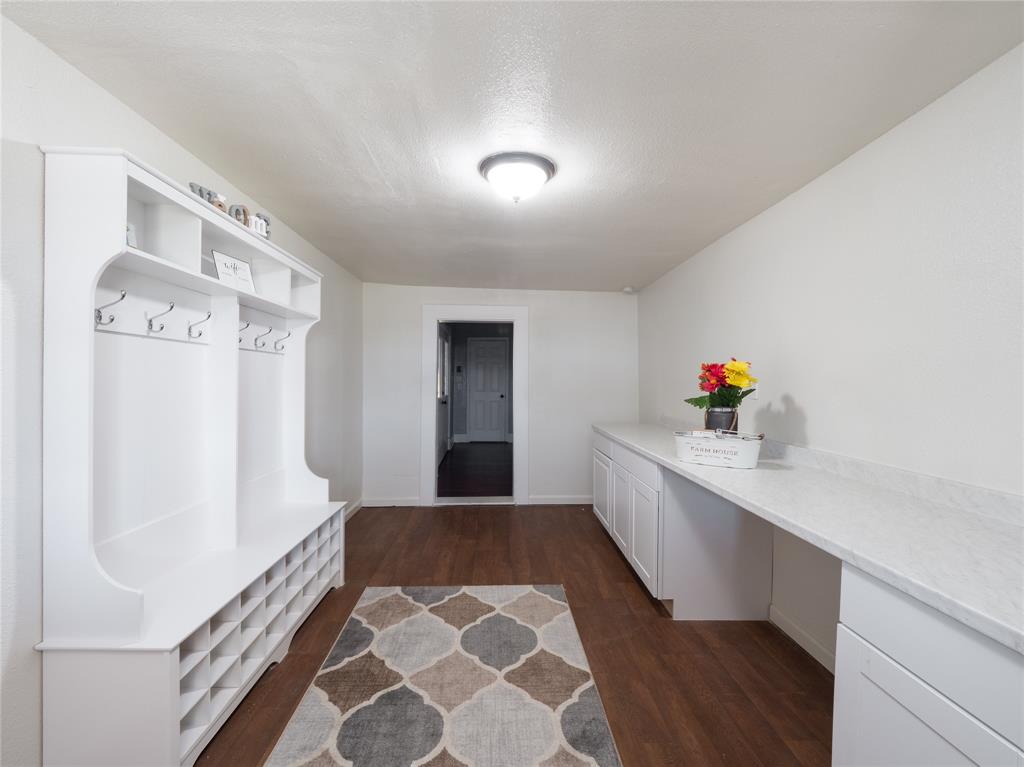 7321 North State Highway Blue Ridge, TX 75424 - Photo 21 of 30 Mudroom featuring dark wood finished floors, a textured ceiling, and built in study area