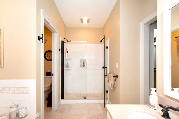 a bathroom with a tub shower and sink