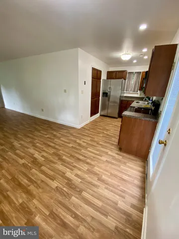 a view of kitchen with refrigerator stove and a window
