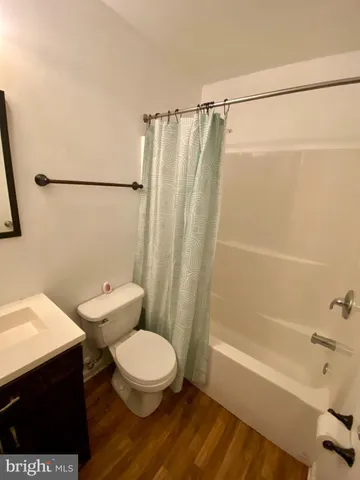 a white toilet sitting next to a bath tub and a shower