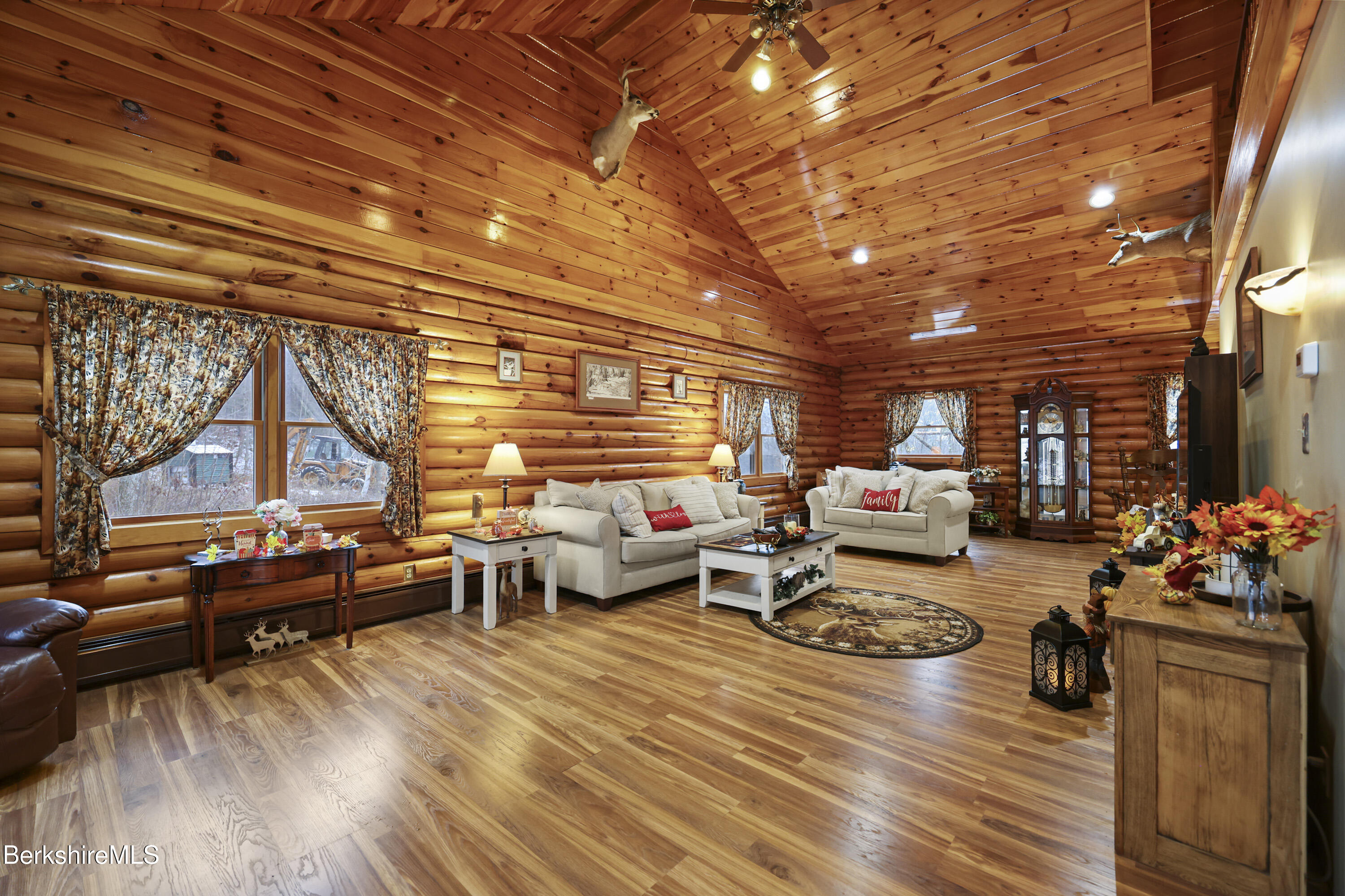 a living room with lots of furniture and a wooden floor