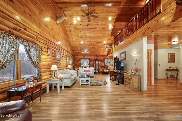 a living room with lots of furniture and a view of kitchen