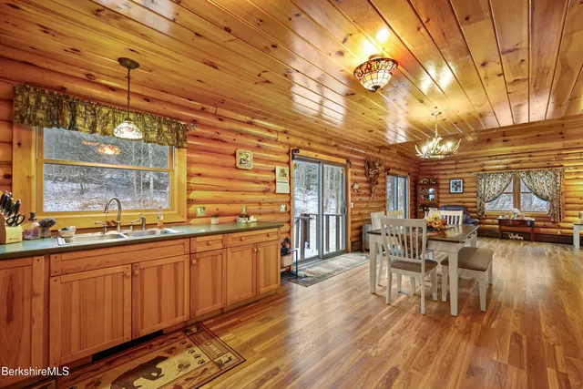 a kitchen with lots of counter top space and wooden floor