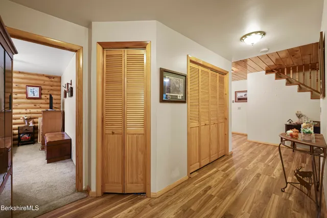 a view of a room with wooden floor and furniture