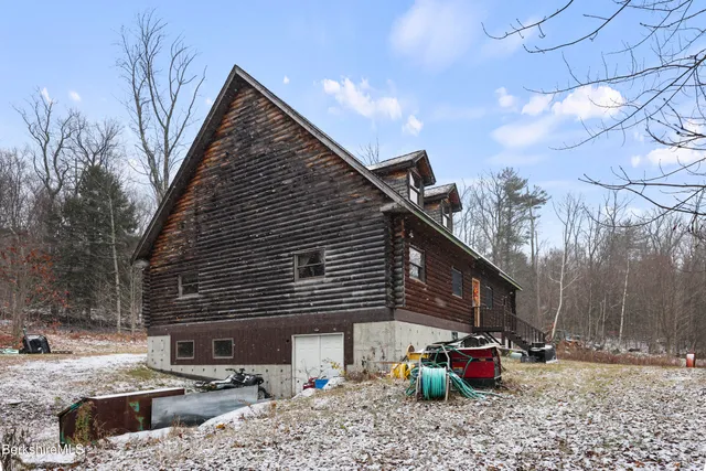 a view of a backyard with a large tree